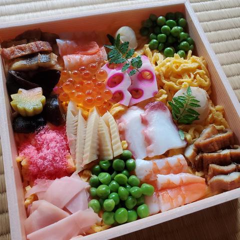 A sumptuous lunch box filled with colourful seafood and vegetables.
