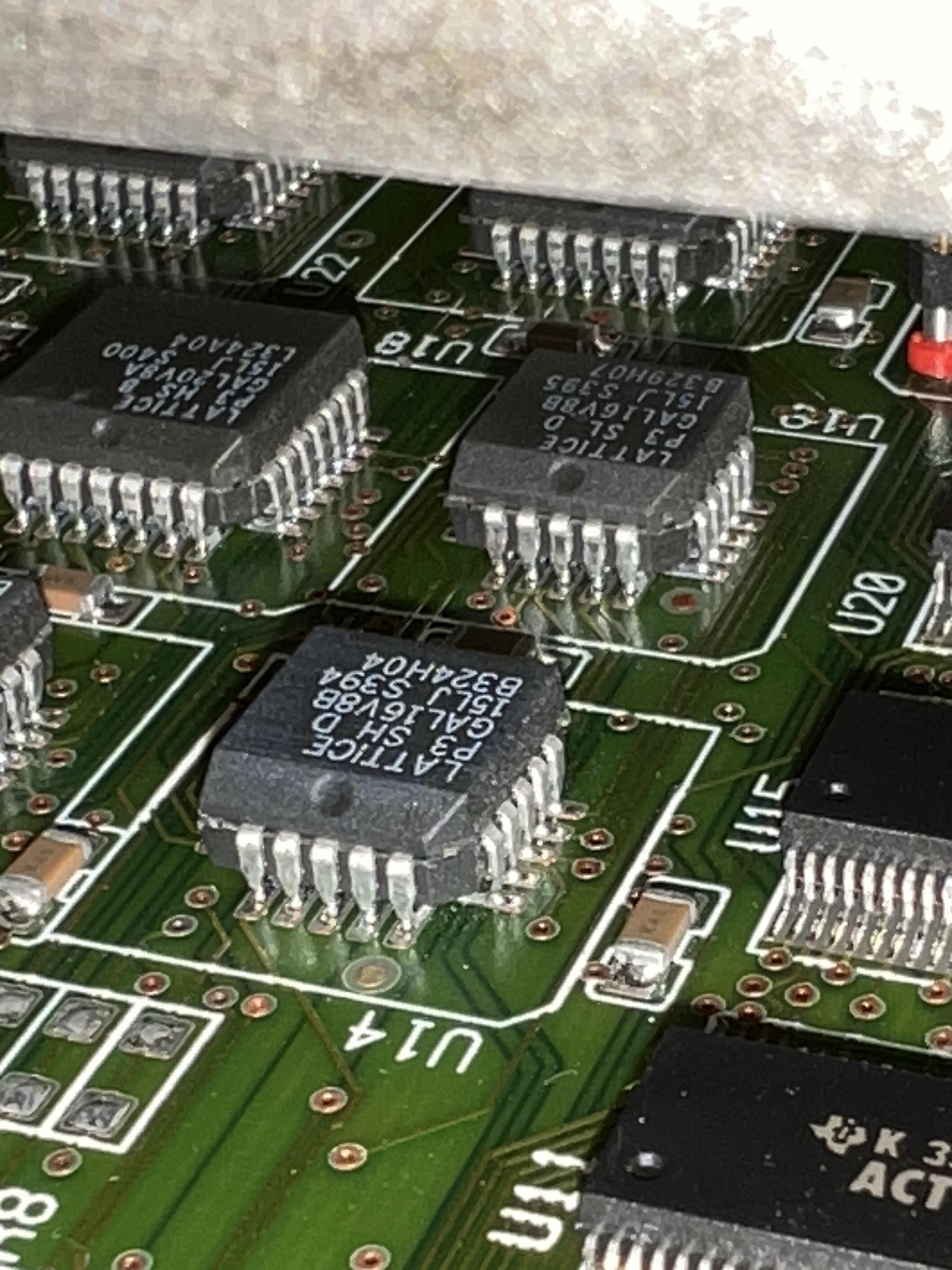 A green circuit board with lots of Latice GALs on it.