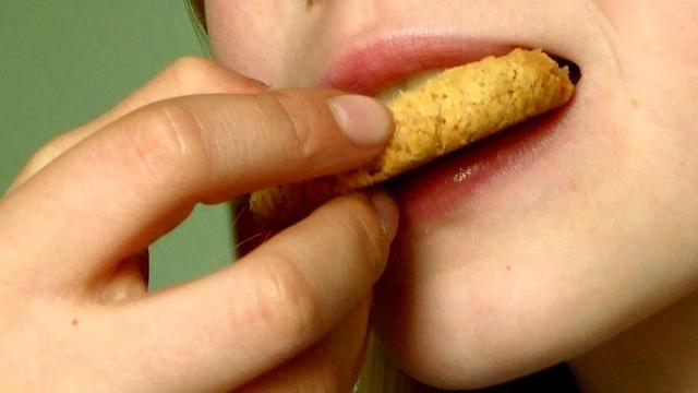 Person eating cookie.