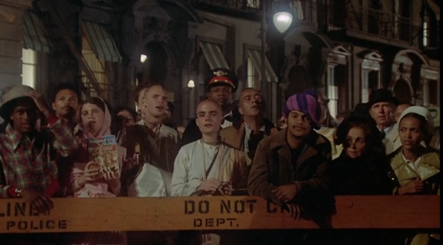 A Hare Krishna or 2, maybe a black pimp, a nurse?   Some other people behind a "DO NOT.." sign with "POLICE" on it some place.