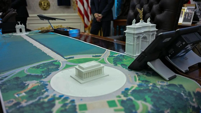 A model of Trump’s triumphal arch for Washington D.C. on the table of the Oval Office.