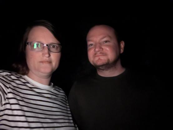 A photo of me and Ric in the dark. We were on a ghost walk and the camera couldn't see anything except our faces, but it wasn't actually that dark.