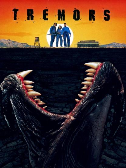 The poster for the movie.

The title is at the top in black lettering.
The main characters stand in front of the sun, in the town, with the monster below.