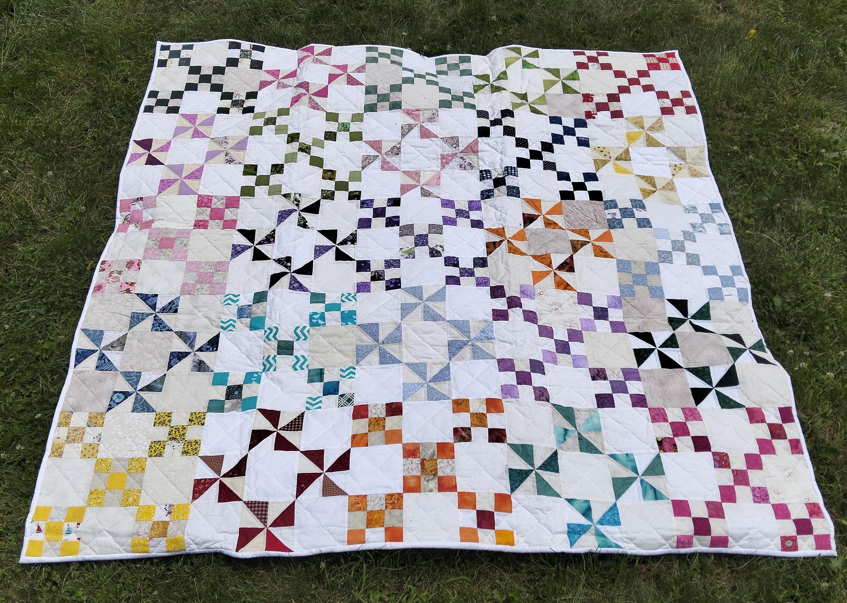 69 x 69 in (175 x 175 cm), it is pinwheel shapes and nine boxes , interlocking together, each different colors