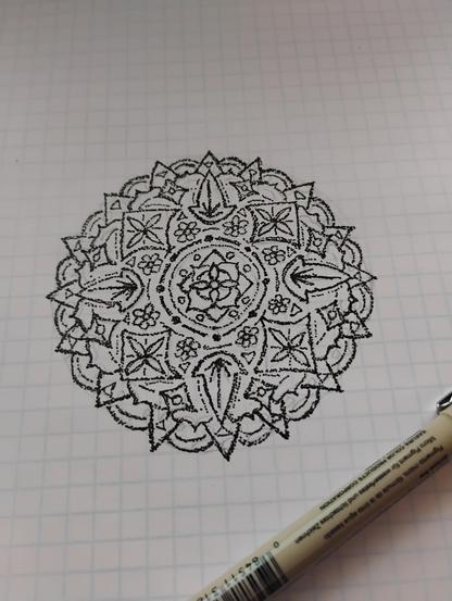 A doodle of a manadla in a stippling style. (Some would say it's a seven, ornate.)