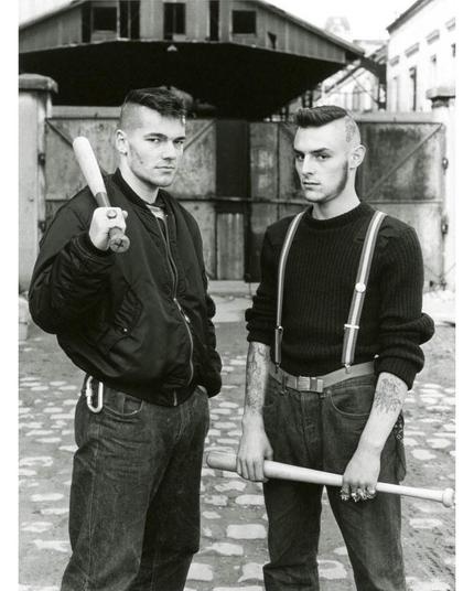 Julien and Jeff posing on a street with their bats, looking at the camera.