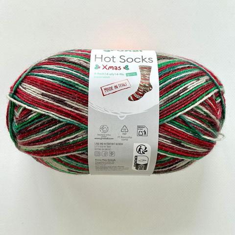A ball of self-striping sock yarn in Christmas green, red, and white. There are some glitters visible as well.