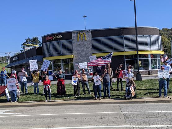 Photo of our local protest in front of us near the mcdonald's with folks with signs and flags. The Bobby Hill 'I don't know you' signs were fantastic.
