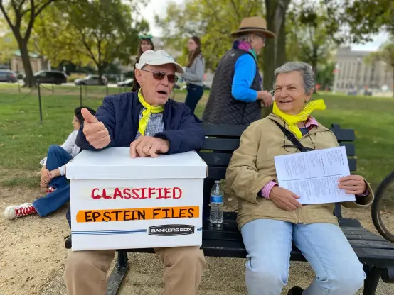 A demonstrator in Washington, D.C., holds a cardboard box labeled "Classified Epstein Files." Jen Bendery/HuffPost