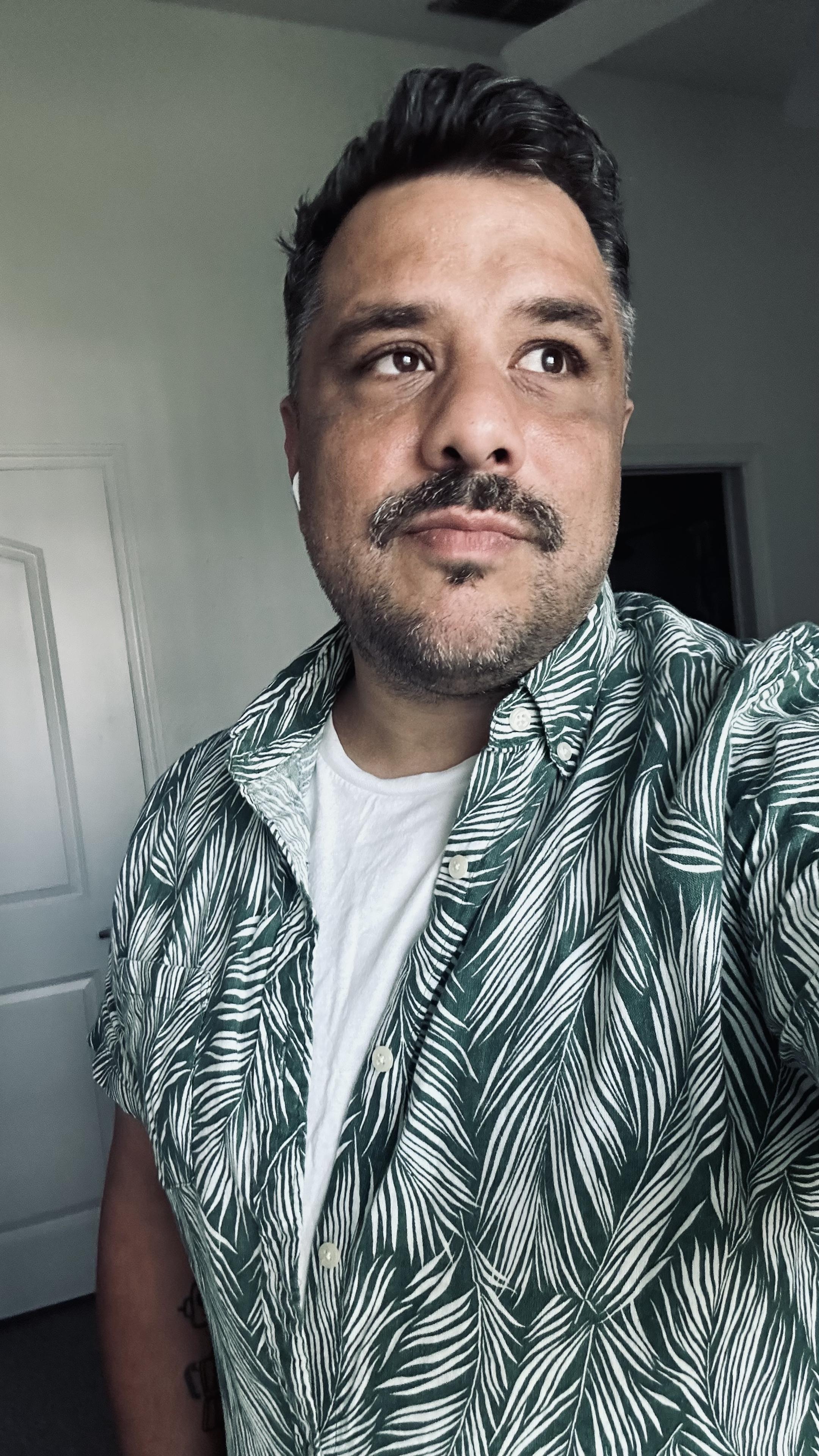 Me in a green and white plant pattern button up, short sleeve. It's nice. 