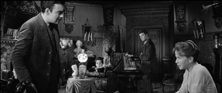 an image of several of the characters in the movie gathered in a parlor room, talking, looking concerned and worried
