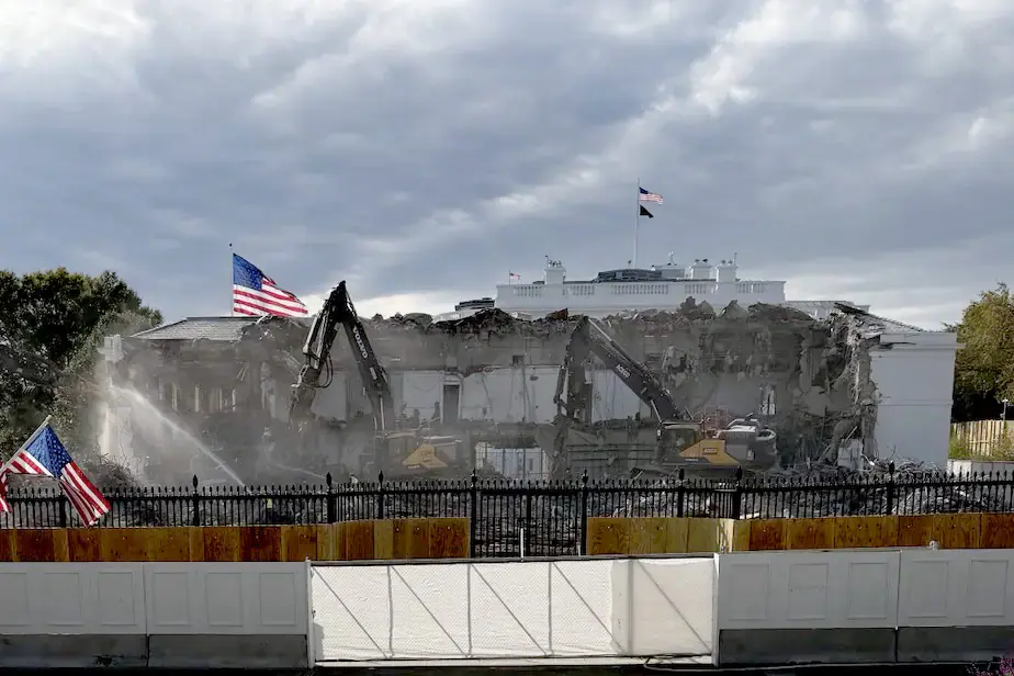 Photo shows part of the white house torn down by two excavators