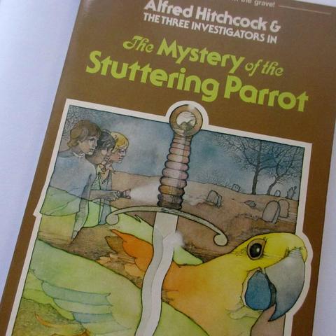 Alfred Hitchcock and The Three Investigators in The Mystery of the Stuttering Parrot - Paperback, with an illustration by Stephen Marchesi, 1978