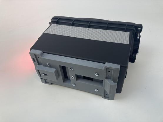 A case with NeoPixel matrix on the back and a battery and controller inside and a MIK attachment.