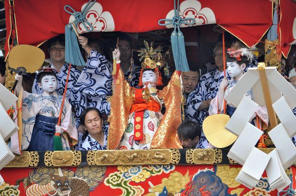The sacred page ('chigo') of the Naginata-boko float, performing during the Gion Matsuri.