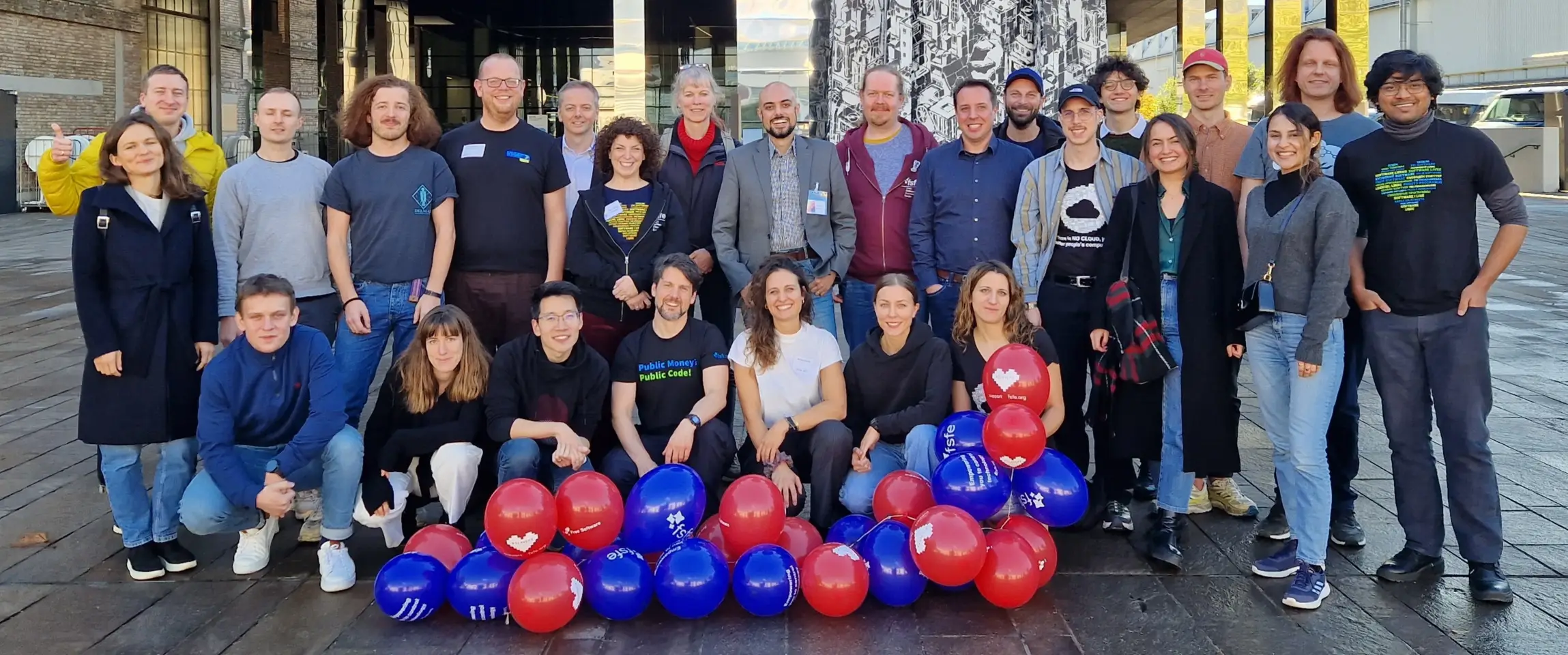The FSFE team posing with FSFE balloons