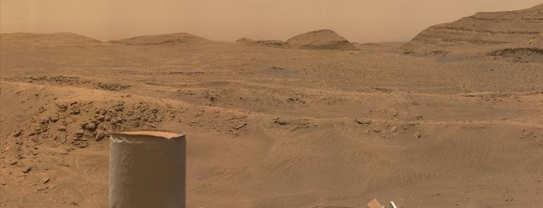 An ochre toned image capturing the boxwork structure, with the rover's UHF antenna in the foreground to the left.