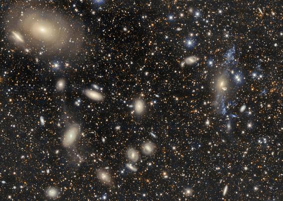 The galaxy cluster Abell 3754 is captured here by the 570-megapixel Department of Energy-fabricated Dark Energy Camera (DECam) on the Víctor M. Blanco 4-meter Telescope, one of around 40 telescopes at the U.S. National Science Foundation Cerro Tololo Inter-American Observatory (CTIO) in Chile, a Program of NSF NOIRLab. 

Located about 200 million light-years away, Abell 3754 is a gravitationally-bound group of hundreds of galaxies. Galaxy clusters are the second-largest-scale structures known in the Universe, but even at their massive scale these galaxies are never all that far from each other. In the top left, the large galaxy IC 4329, surrounded by rings of light, shows evidence of a past cosmic collision. The spread-out fragments of illuminated blue and white gas on the right side of the image are evidence of a similar clash with the galaxy NGC 5291 (yellow color). If you look closely, you can see more evidence of gravitationally interacting galaxies. 