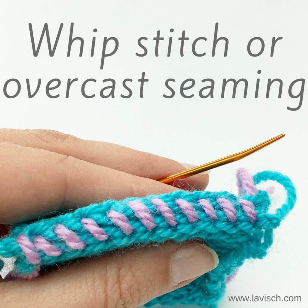Someone is holding up some knitting in turquoise yarn, there is an overcast seam visible in lilac yarn.