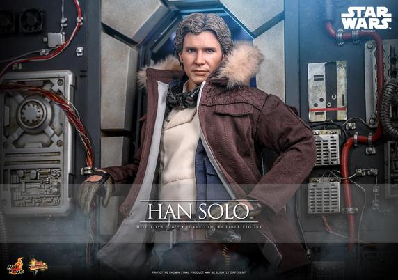 Photo en situation de la figurine de Han Solo. 
Il se tient dans un passage du Faucon Millenium. Il regarde l'objectif. Il porte sa parka de Hoth en marron, sur sa veste bleue et l'on voit sa chemise blanche. Il s'appuie nochalament sur le passage avec son bras droit alors que sa main gauche se repose sur sa hanche gauche.