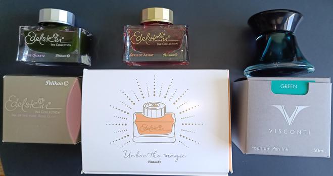 Pictured Pelikan Rose Quartz, Pelikan Apricot Achat and Visconti Green with their packaging and a box from pelikan hub.