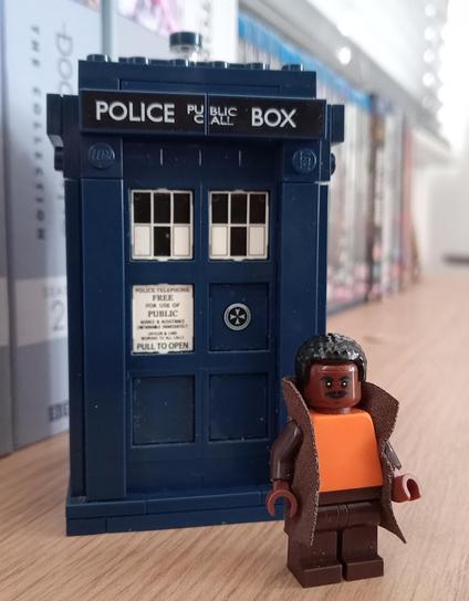 My personalized 15th Doctor minifigure, standing in front of the TARDIS 