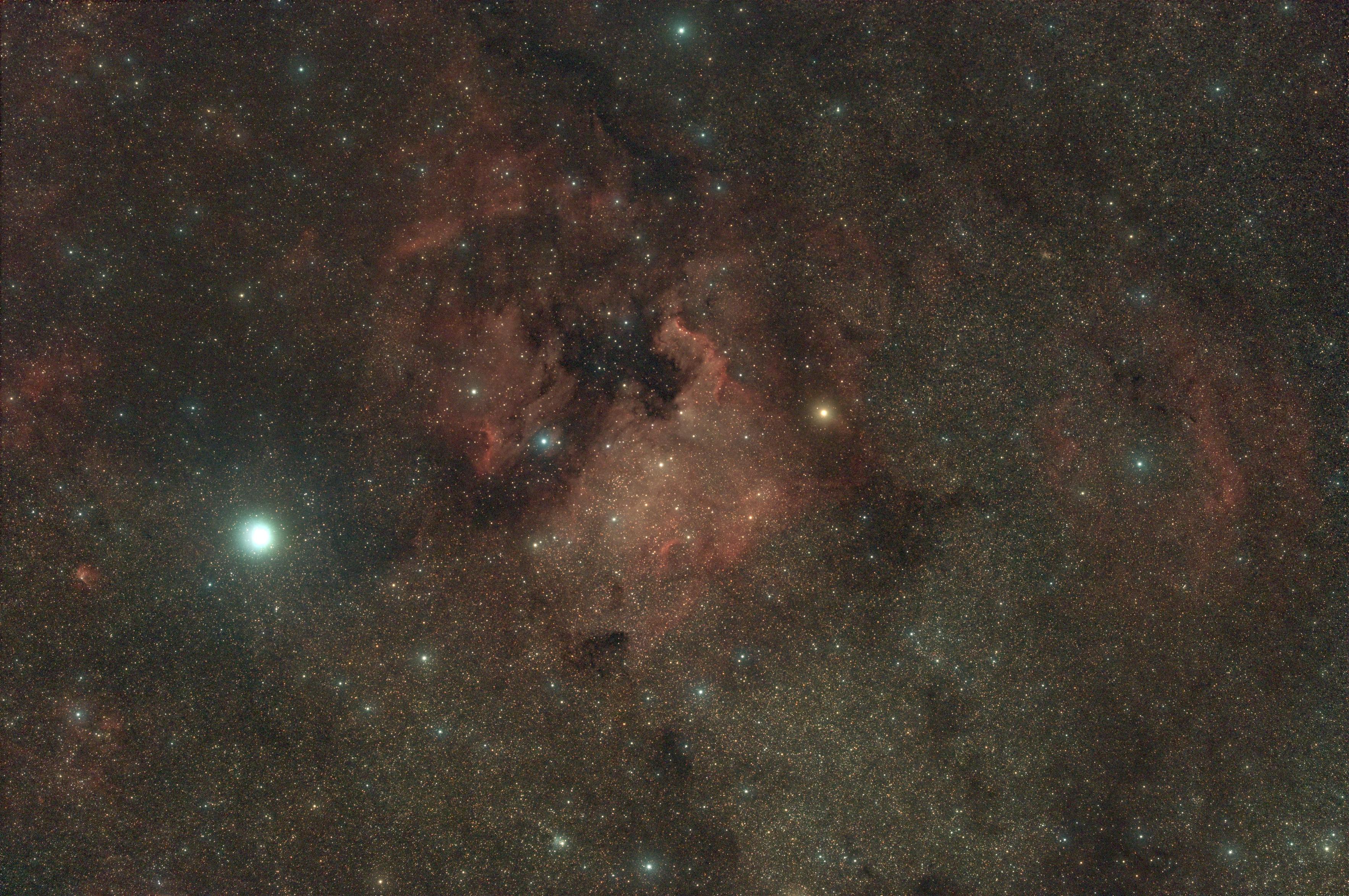 Deep sky astro image showcasing the north america nebula and the surrounding regions. Plenty of stars, emission nebulae and dark nebulae throughout the image.