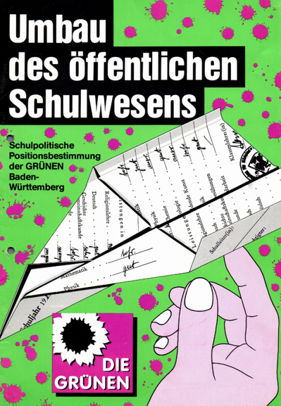 Vor einem mit lila Tintenflecken übersäten grünen Hintergrund ist eine Comic-Hand zu sehen, die ein als Papierflieger gefaltetes Zeugnis wirft. Oben steht groß "Umbau des öffentlichen Schulwesens" (Helvetica, weiß auf schwarz, wenn ich das richtig identifiziere). Unten links ist ein Logo "Die Grünen" zu sehen, zum damaligen Zeitpunkt ein lila Quadrat mit Schattenwurf und Sonnenblume in schwarz-weiß.