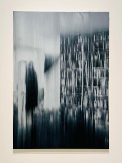 a painting that is an abstraction of a person walking by a bookcase