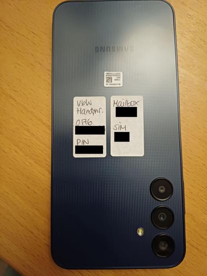 Stickers on back of phone show to anyone who looks the number, PIN, mailbox code, and SIM access code.