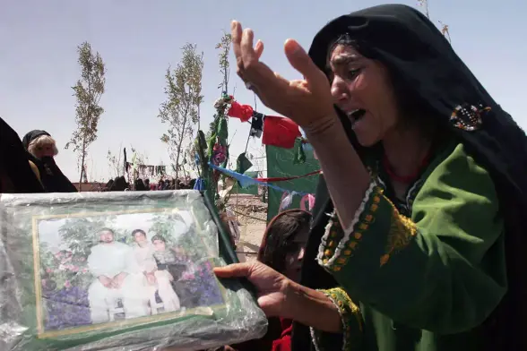Afghan woman mourns family members who were killed in Herat Province in August 2008.