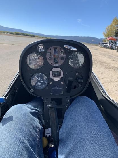 The instrument panel of a glider and the knees of the pilot