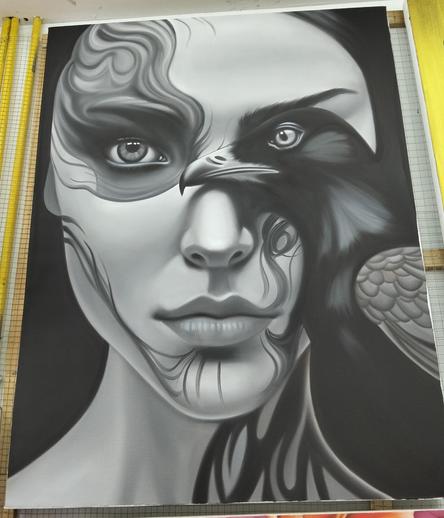 a painting, it is of a slender feminine figure looking at the viewer, long dark hair, one eye smoldering with energy, the other half of her face covered by a black bird's body facing left 