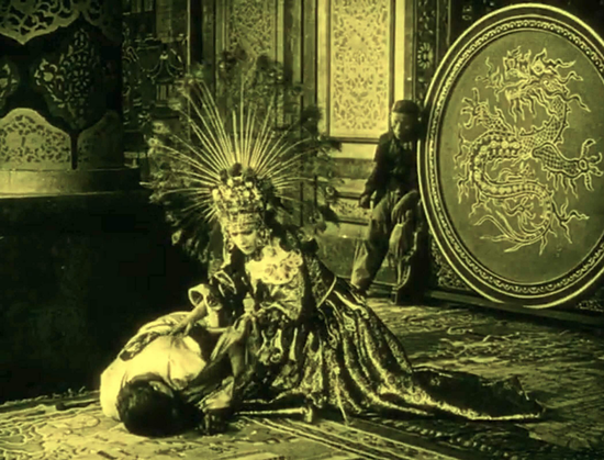 an image of a woman in an ornate dress, a big feathered peacock head dress, a body on the floor of the palace, she is on her knees, trying to awaken him , a big round shield behind her with a dragon on it, a man slumped next to it