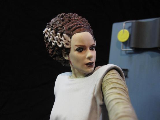 X-Plus bride of Frankenstein model kit. White gowned Bride with tan bandages. A red scar around the ear and neck.