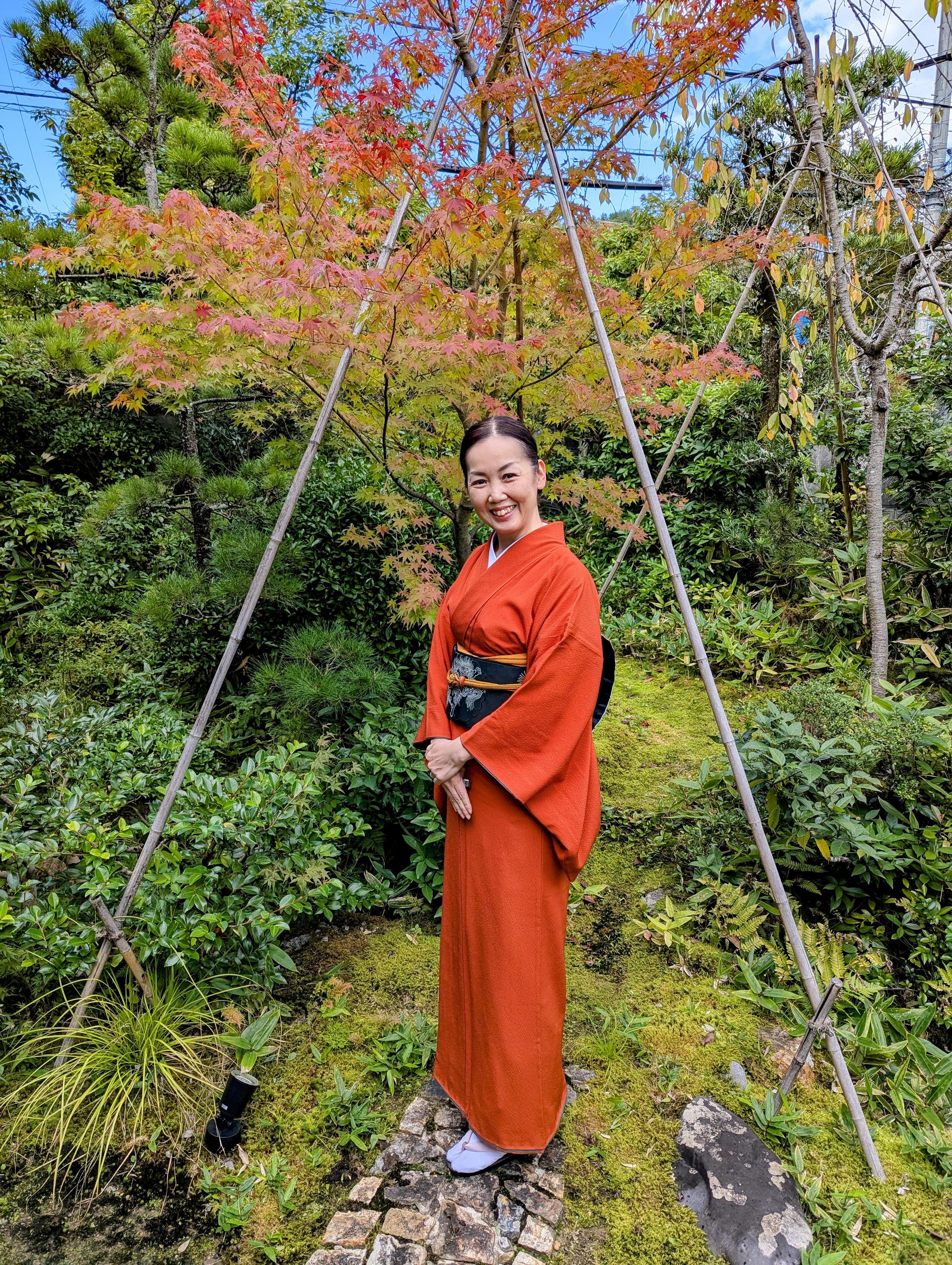 Atsuko-san dressed in an orange kimono and black obi, a nod to the Jack-o'-lanterns found at this time of year.