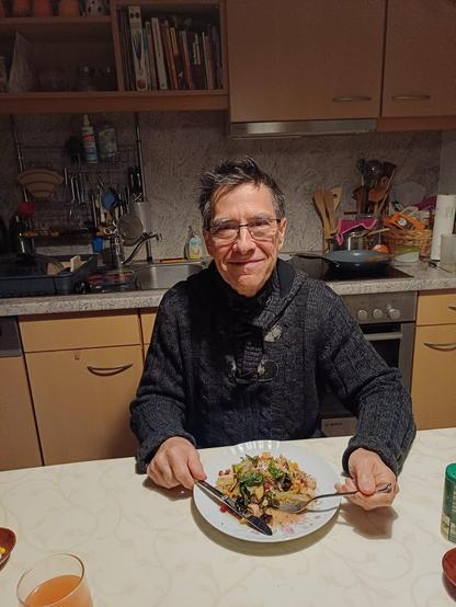 Me tonight at our kitchen table eating my wife's serving of my Pecan Chicken Bok Choy recipe.