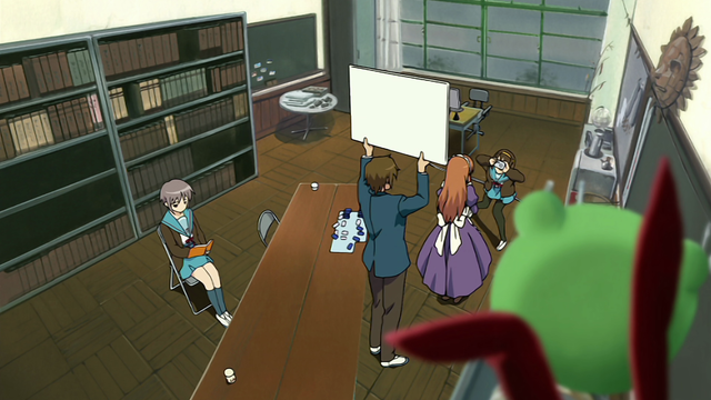 A girl (Haruhi) taking photos of a girl (Mikuru) in a maid costume while a boy (Itsuki) holds up a board and a girl (Yuki) is reading in the background.