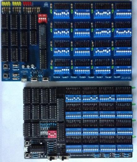 Photo of the original TD4 logic chip computer next to my own PCB implementation of the same thing.  They both have a bank of 16 8-way DIP switches arranged in a 4x4 grid on the righ; and all the logic chips (13 in total) on the left.  The original has a small bank of surface mount LEDs for OUTPUT and a 4-way DIP switch for INPUT.  Mine has that too, but they are moved to the top left of the board and I've added two banks of LEDs to show the state of the registers.  My PCB also has an LED per 8-way DIP switch used to show which instruction is being worked on.  My PCB is about 1cm taller and 3cm wider than the original, which itself is around 10x15cm.