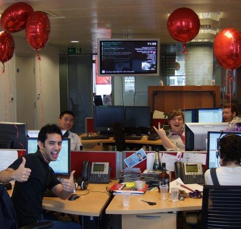 continuously improve work life: photograph of happy workers in an office. Photo attribution: Flickr user jamescridland
