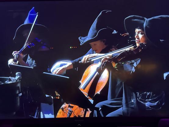 Three string musicians dressed up as witches who played with Billy Strings in Baltimore tonight at their Halloween-themed concert.