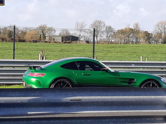 timf in a green Mercedes AMG GT-R