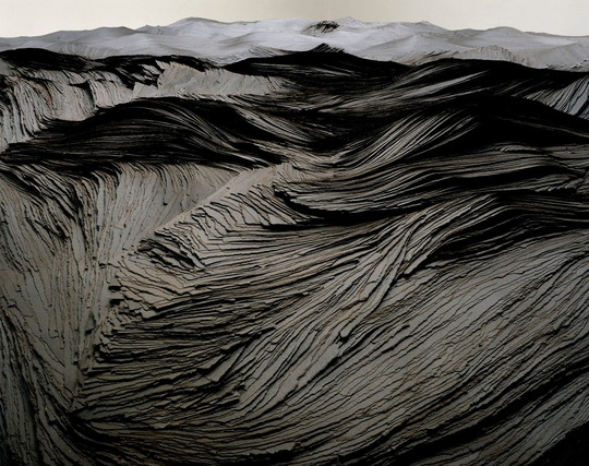 View 2, detail: The sculpture is an aggregation of hundreds of thousands of brown tar paper strips, stacked at varying heights and widths to suggest an undulating landscape or ocean waves. 