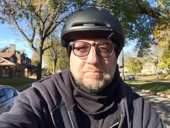 A human man person with a helmet riding a bike.