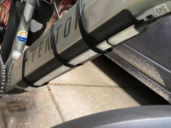 An LED strip strapped to the bottom tube of an ebike.
