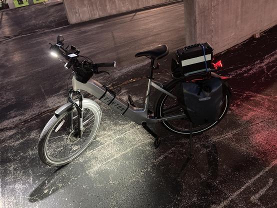 An LED strip strapped to the bottom tube of an ebike.