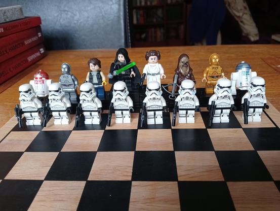 LEGO Characters from the original Star Wars Trilogy, set up as chess pieces 

KING: ROTJ Luke
QUEEN: ANH Leia
BISHOP: Han Solo
BISHOP: Chewbacca
KNIGHT: U3PO
KNIGHT: C3PO
ROOK: R4D4
ROOK: R2D2
PAWNS: Stormtroopers
