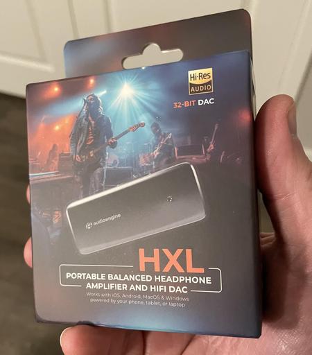 Photo of the AudioEngine HXL portable DAC package in my hand. This little box traveled far and wide before finally arriving.