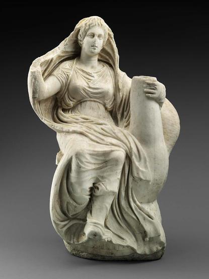 This marble sculpture of Aphrodite riding a goose may have been a votive gift in a sanctuary, but the roughly finished back makes it more likely that the piece was a roof decoration (akroterion) for a temple where it would have been seen from one side only. In Roman times the sculpture was taken to Italy and used in a fountain; a hole was drilled through the goose's neck for the passage of water. The goddess is seated on the back of the goose. She grasps the bird's neck with her left hand; her …
