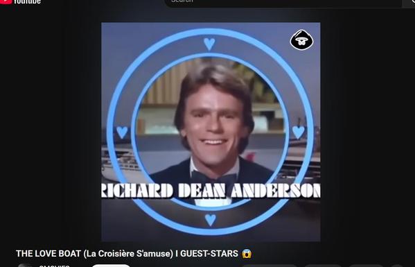 Image of a screencap of a youtube video showing guest stars in the show the love boat, with a young richard dean anderson grinning like a schoolkid